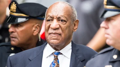 Bill Cosby surrounded by the police
