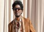 Labrinth in an event wearing a brown jacket