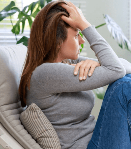 a woman sitting on the sofa looking stressed