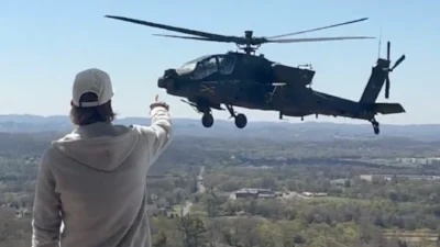 Kid Rock pointing at a military aircraft