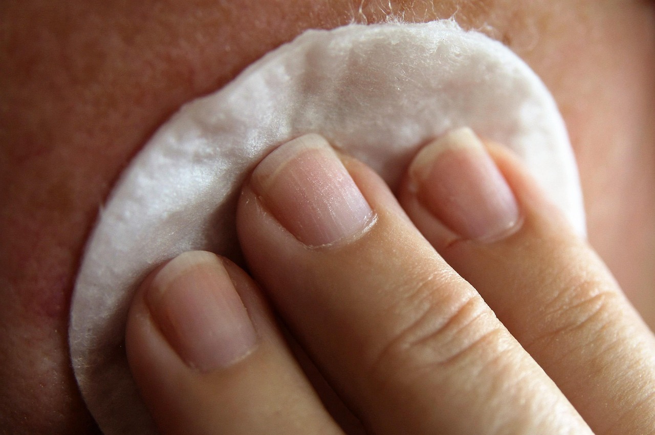 applying cleanser on face