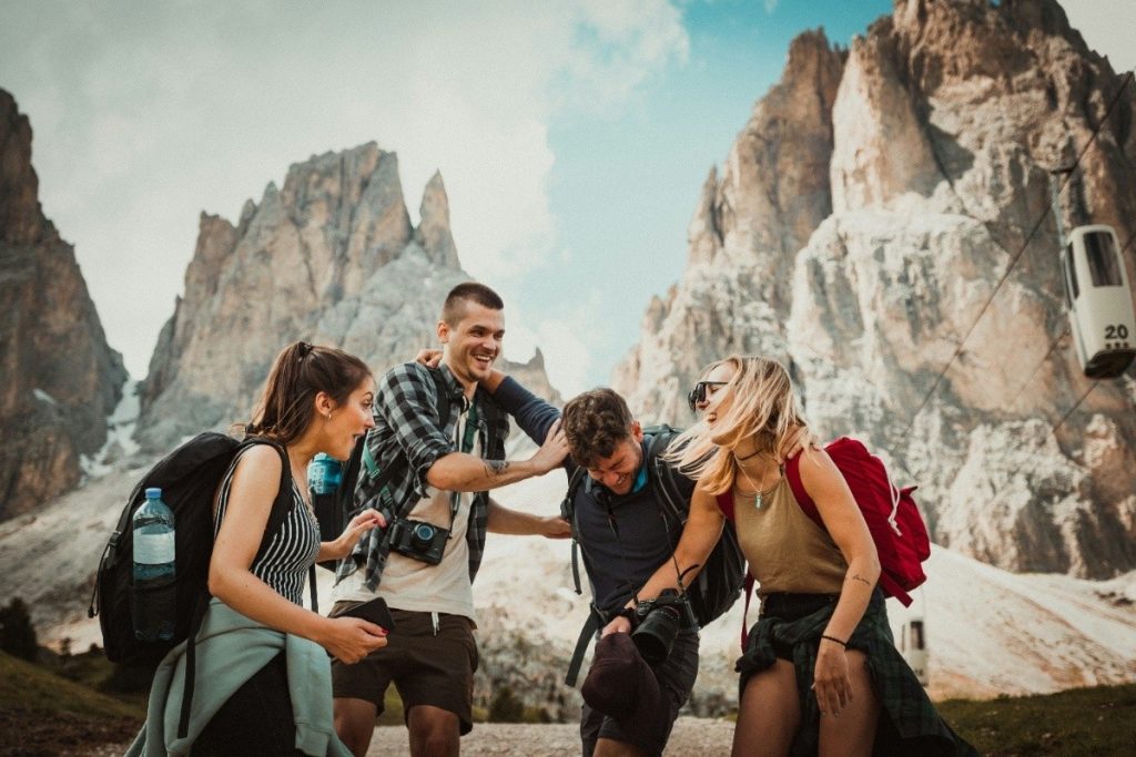 Budget Friendly Travel Tips for Smart and Stylish Adventures Two men playing beside two women, sharing laughs and moments inspired by budget friendly travel tips.