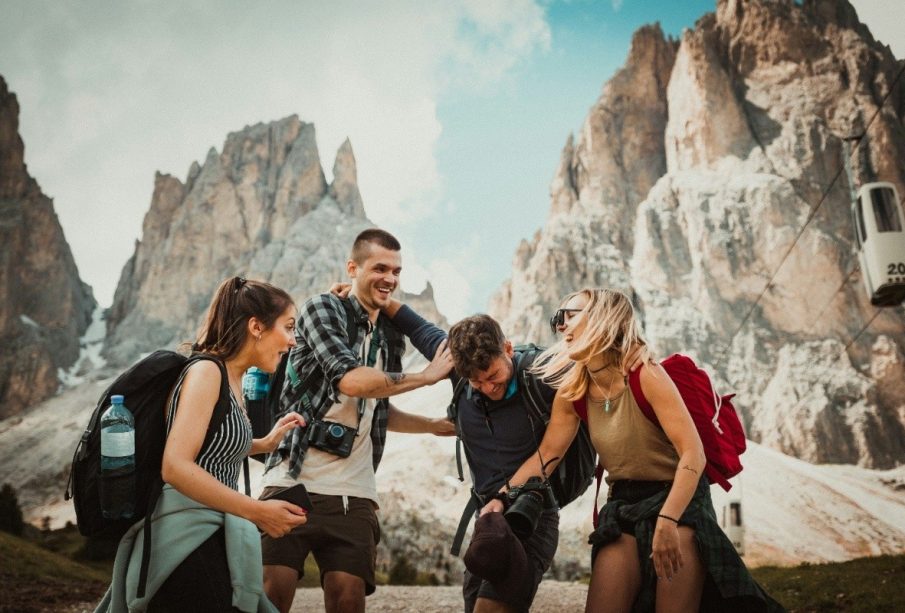 Two men playing beside two women, sharing laughs and moments inspired by budget friendly travel tips.