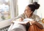 A lady journaling indoors, illustrating how journaling can improve your life.