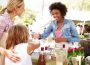 A woman and her child having a converation with a stall owner, illustrating How to Experience a City Like a Local