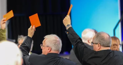 Men raising cards up in support of same sex marriage