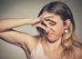 A woman covering her nose with her hands