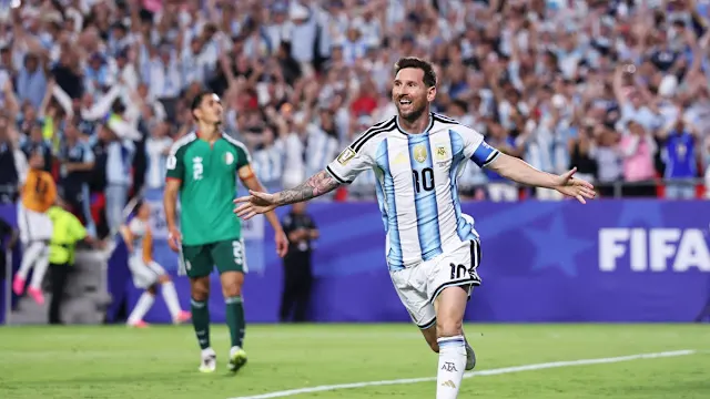 Messi Hat-Trick Overshadowed by Red Card Controversy as Argentina Beat Algeria in World Cup Match Lionel Messi celebrating a hat-trick during Argentina vs Algeria World Cup match as a referee shows a red card amid controversy.