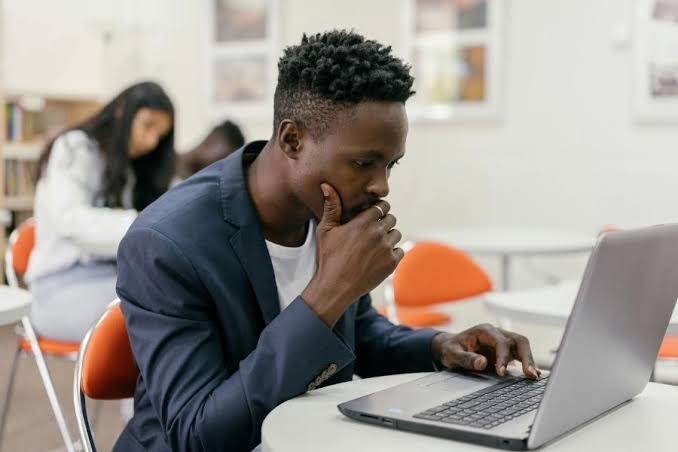 How to Make Money Online as a Nigerian Student: Practical Ways to Earn While Studying Nigerian university student using a laptop to earn money online while studying in a campus environment.